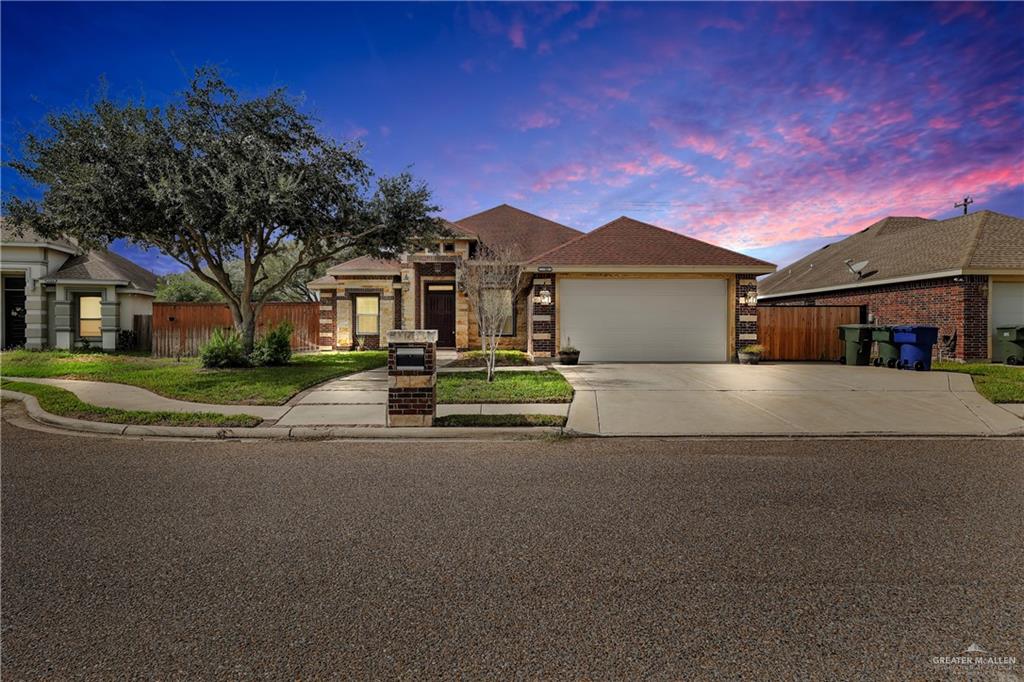 a front view of a house with a garden and trees