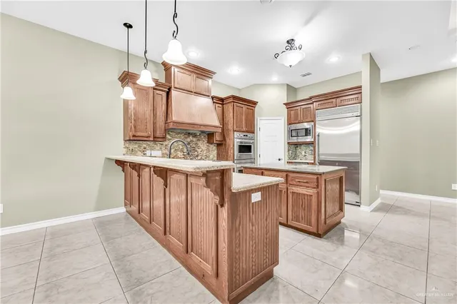 a kitchen with stainless steel appliances granite countertop a sink and a stove