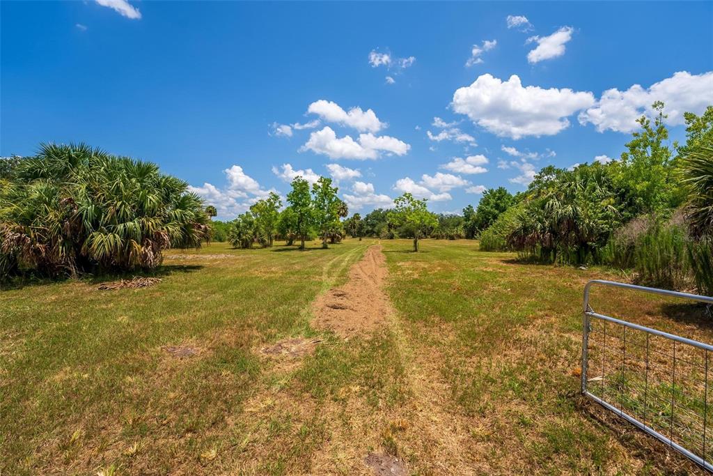 Waccassa Street Geneva, FL 32732 - Photo 15 of 23 a view of a swimming pool with an outdoor space and seating area