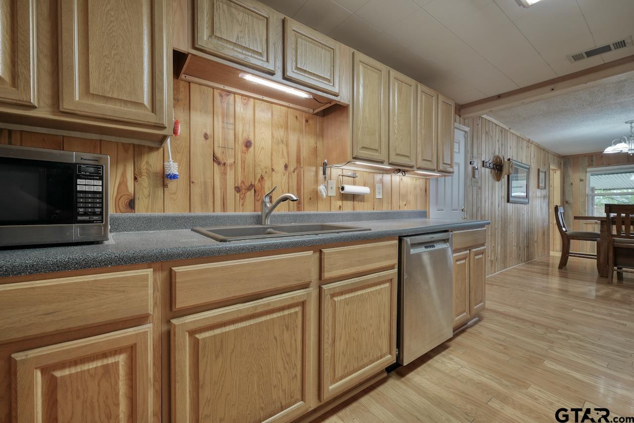 667 Allen Road Longview, TX 75605 - Photo 16 of 48 a kitchen with cabinets and a wooden floor
