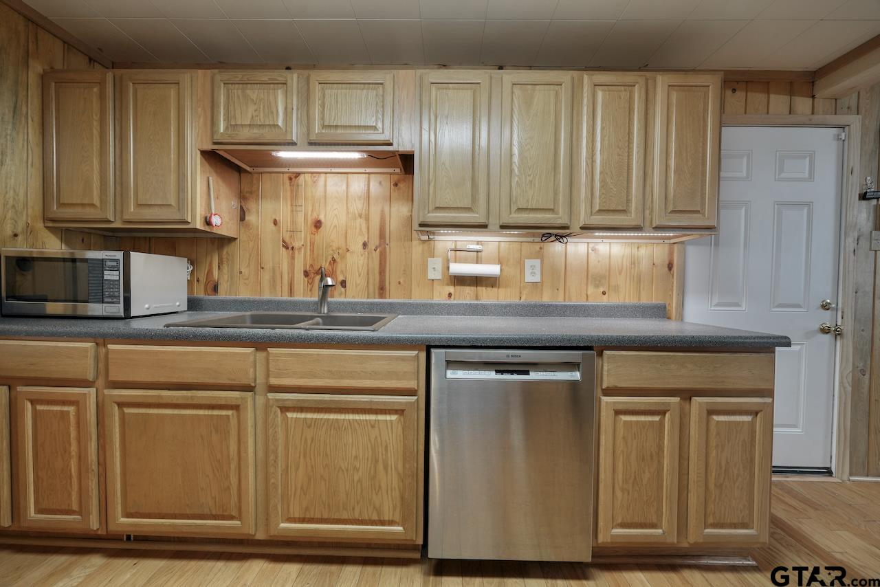 667 Allen Road Longview, TX 75605 - Photo 18 of 48 a kitchen with granite countertop cabinets and black appliances