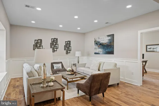 a living room with furniture and wooden floor