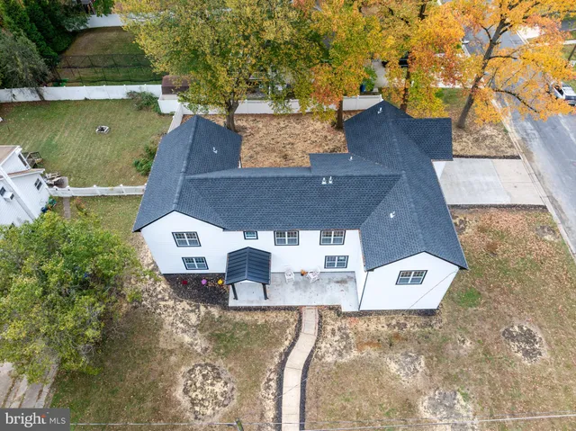an aerial view of a house with swimming pool and a yard