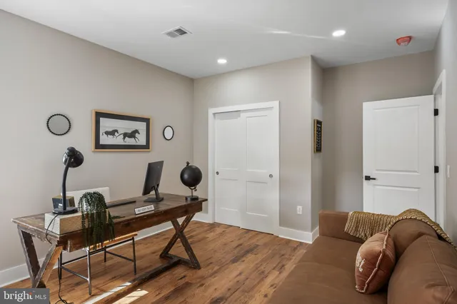 a living room with furniture and wooden floor