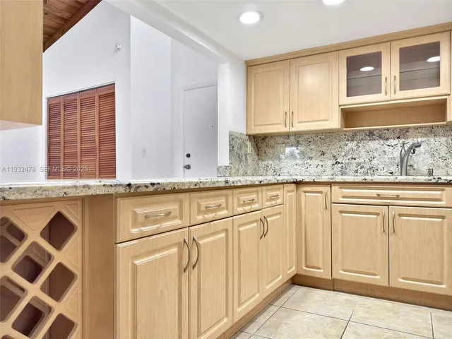 a view of room with wooden floor and a ceiling fan