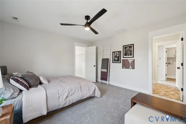 a bedroom with a bed and painting on the wall