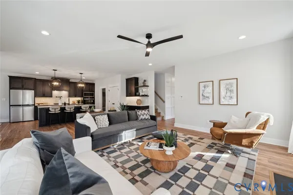 a living room with furniture and kitchen view