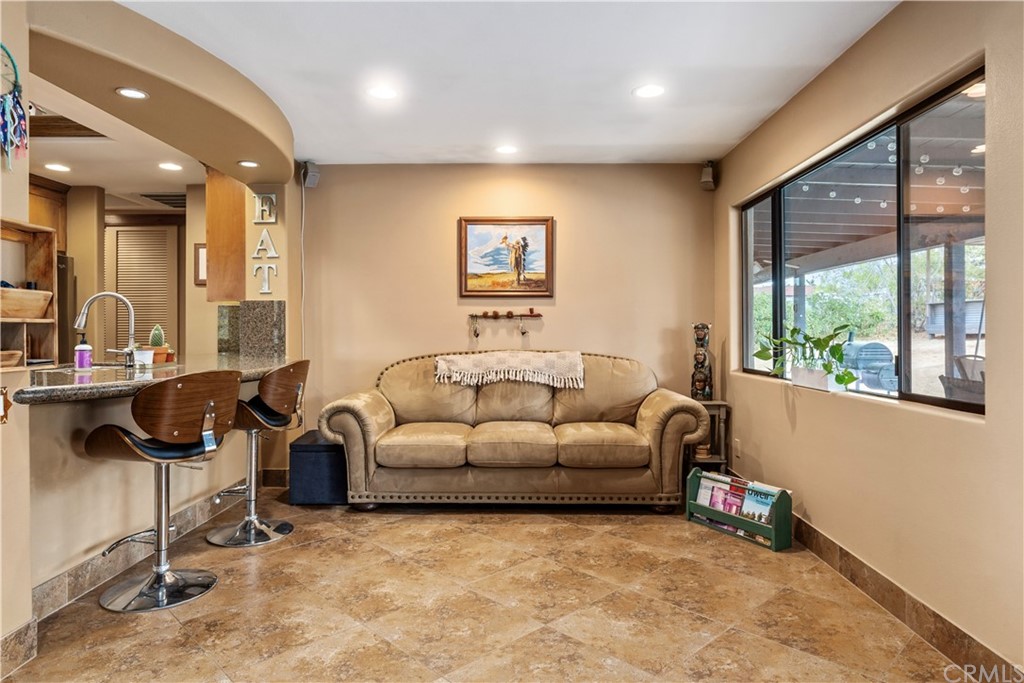 60467 Natoma Trail Joshua Tree, CA 92252 - Photo 14 of 63 a living room with furniture and a large window