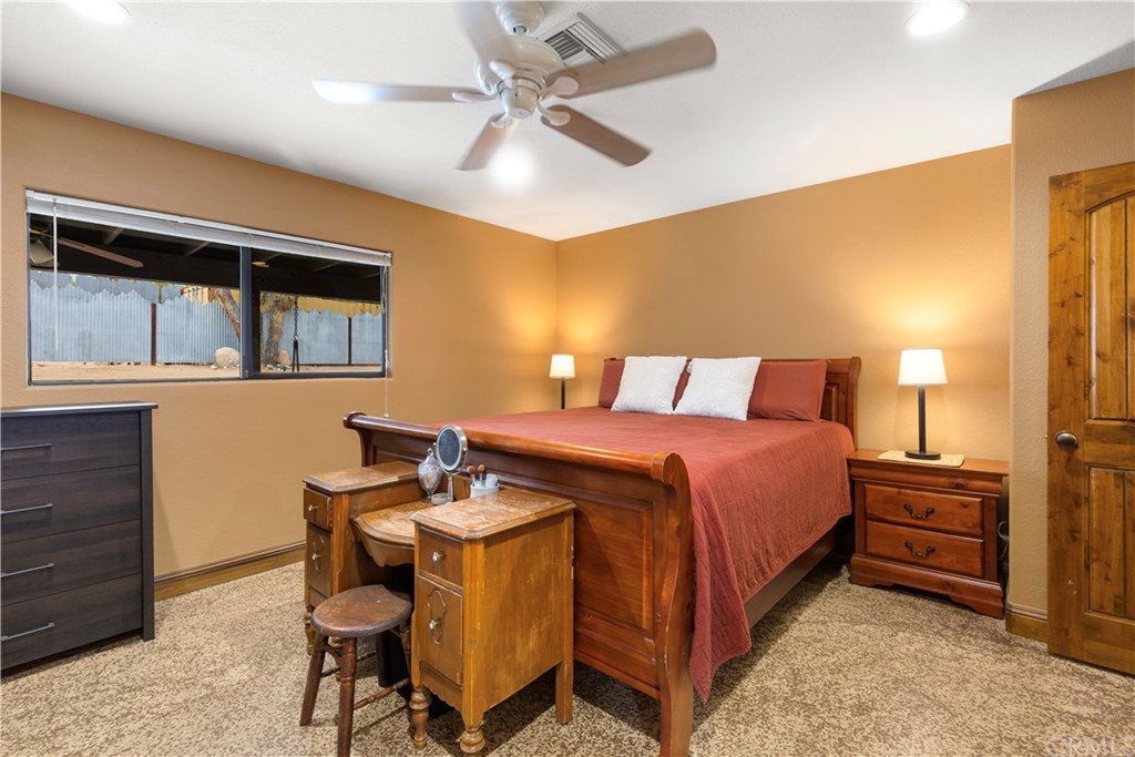 60467 Natoma Trail Joshua Tree, CA 92252 - Photo 19 of 63 a bedroom with a bed and a table