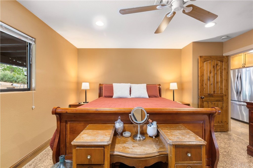 60467 Natoma Trail Joshua Tree, CA 92252 - Photo 20 of 63 a bedroom with a bed and wooden floor