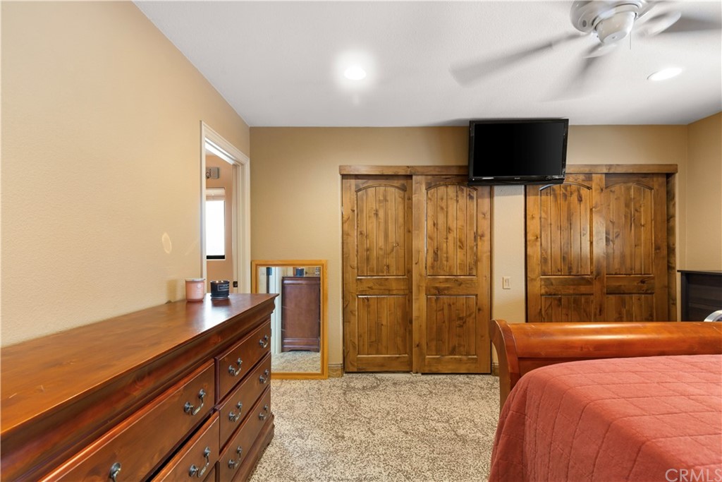 60467 Natoma Trail Joshua Tree, CA 92252 - Photo 22 of 63 a bedroom with a bed and a flat screen tv