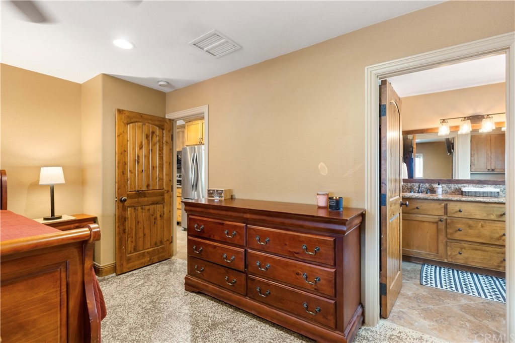 60467 Natoma Trail Joshua Tree, CA 92252 - Photo 23 of 63 a bathroom with a granite countertop sink and a mirror