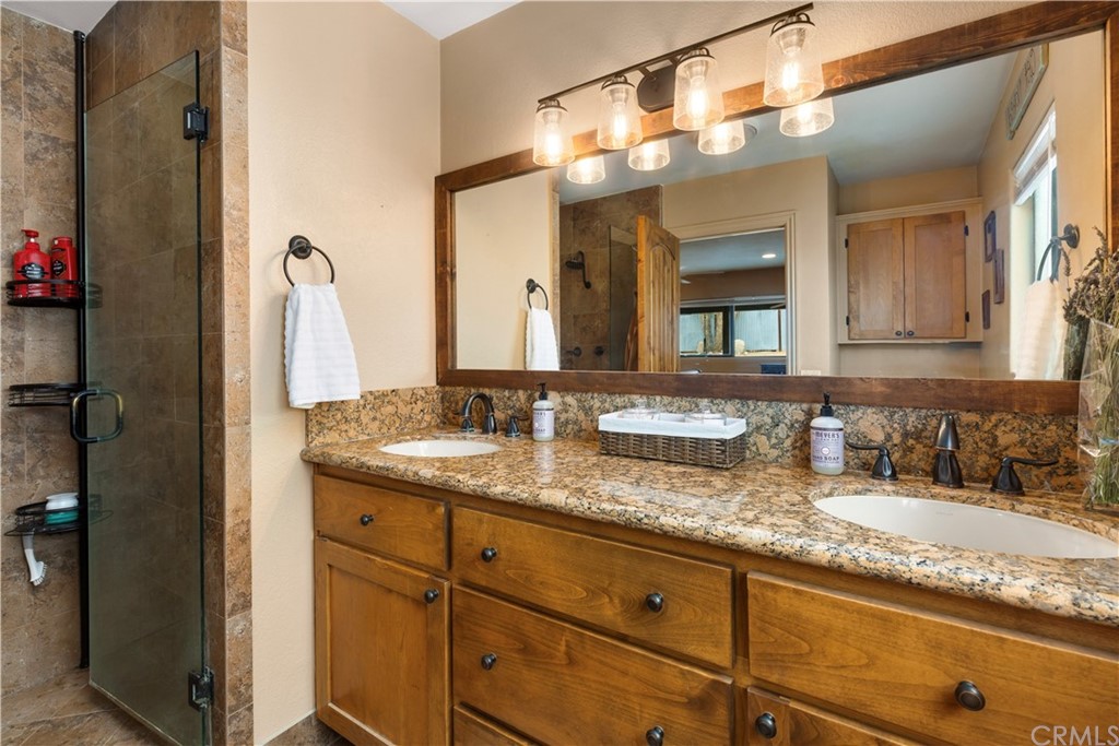 60467 Natoma Trail Joshua Tree, CA 92252 - Photo 25 of 63 a bathroom with a granite countertop sink and a mirror