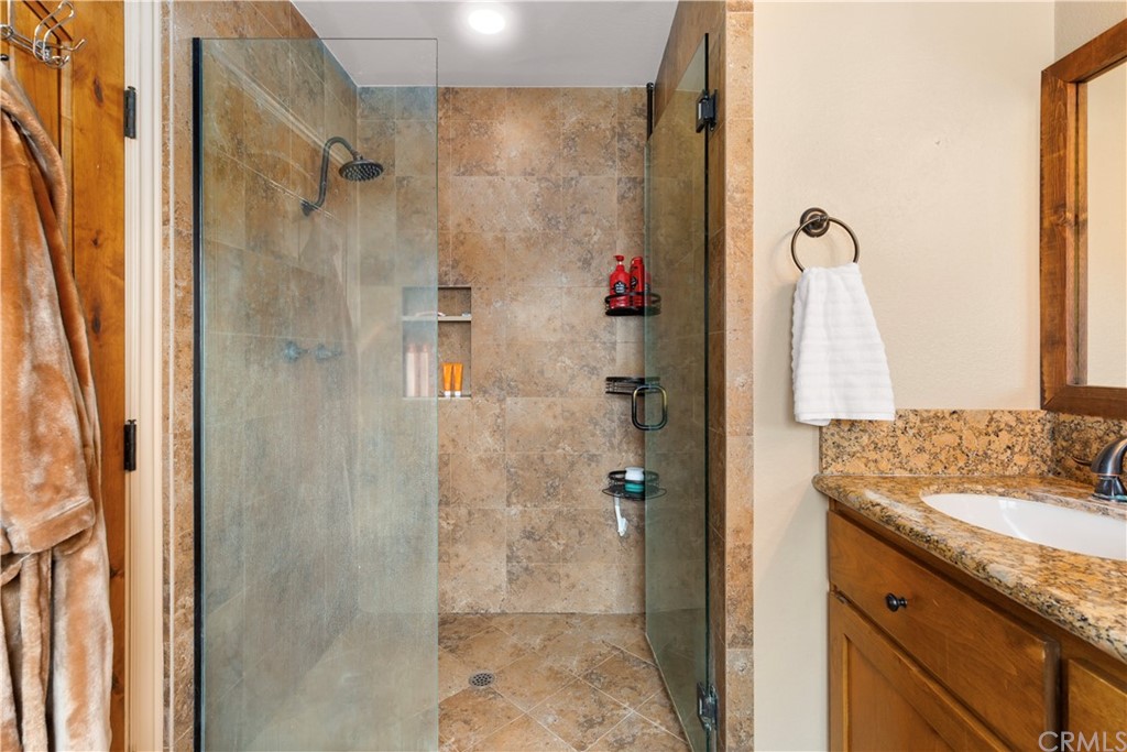 60467 Natoma Trail Joshua Tree, CA 92252 - Photo 26 of 63 a bathroom with a granite countertop shower mirror and a sink