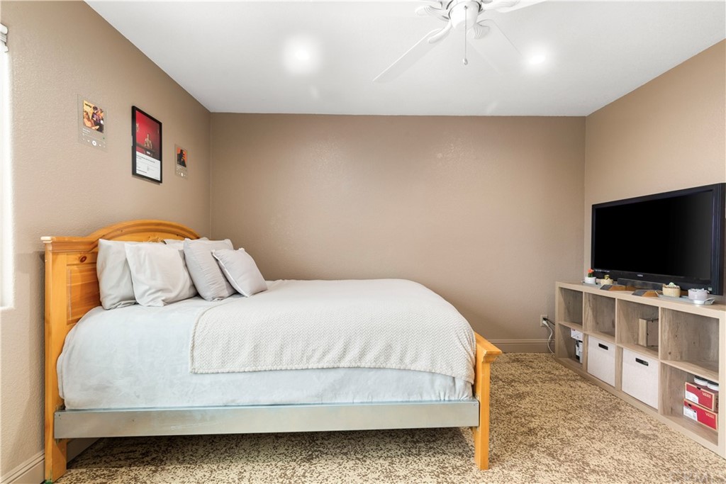 60467 Natoma Trail Joshua Tree, CA 92252 - Photo 31 of 63 a bedroom with a bed and a flat screen tv