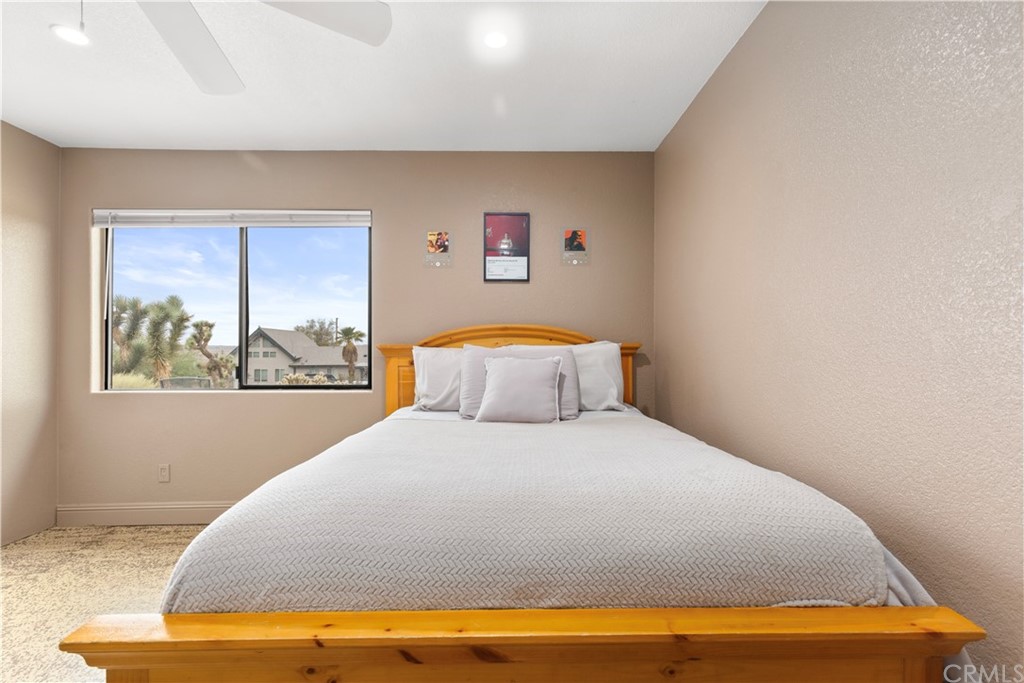 60467 Natoma Trail Joshua Tree, CA 92252 - Photo 33 of 63 a bedroom with a bed and painting on the wall