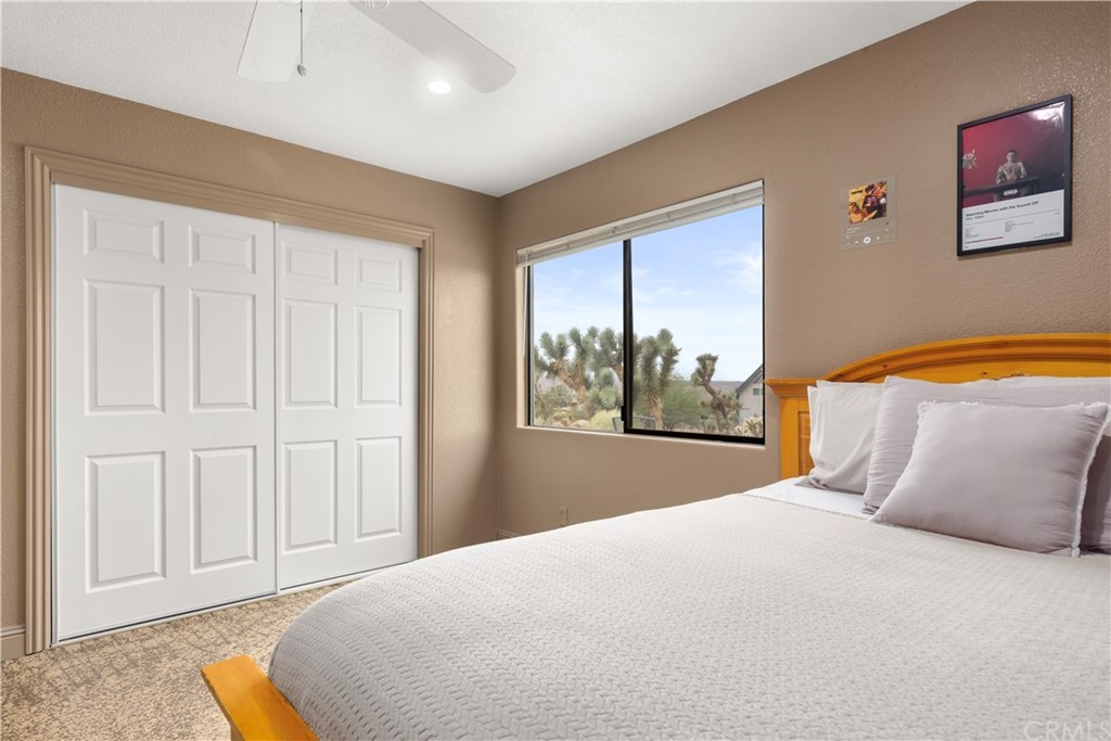 60467 Natoma Trail Joshua Tree, CA 92252 - Photo 36 of 63 a bedroom with a large bed and a window