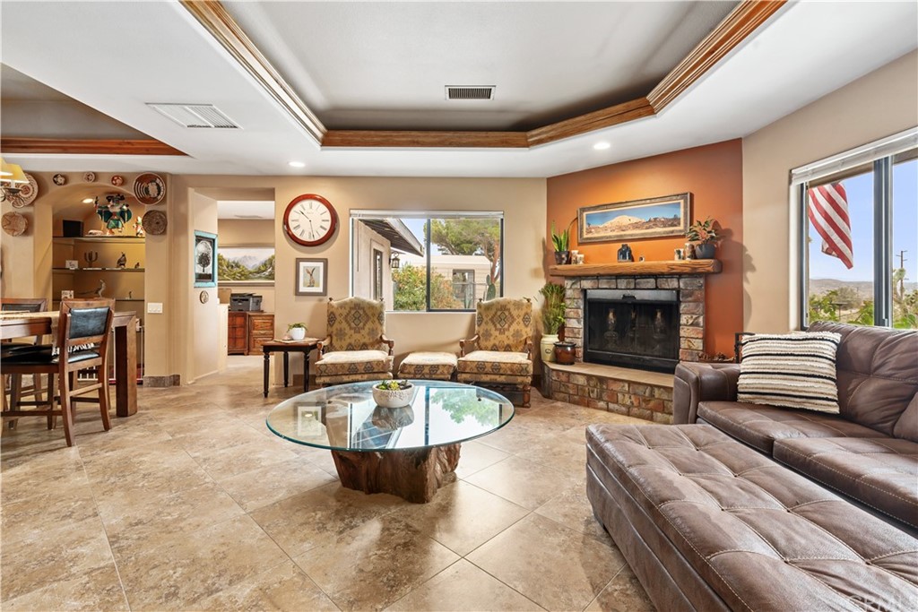 60467 Natoma Trail Joshua Tree, CA 92252 - Photo 5 of 63 a living room with furniture a fireplace and a flat screen tv
