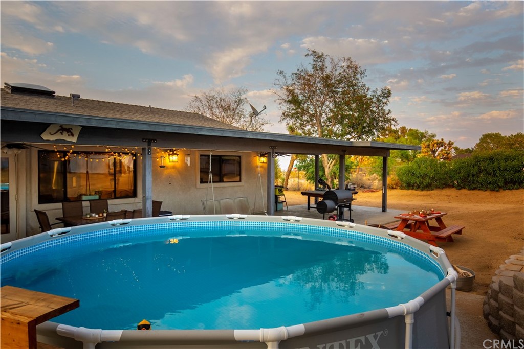 60467 Natoma Trail Joshua Tree, CA 92252 - Photo 50 of 63 a view of a swimming pool with an outdoor seating