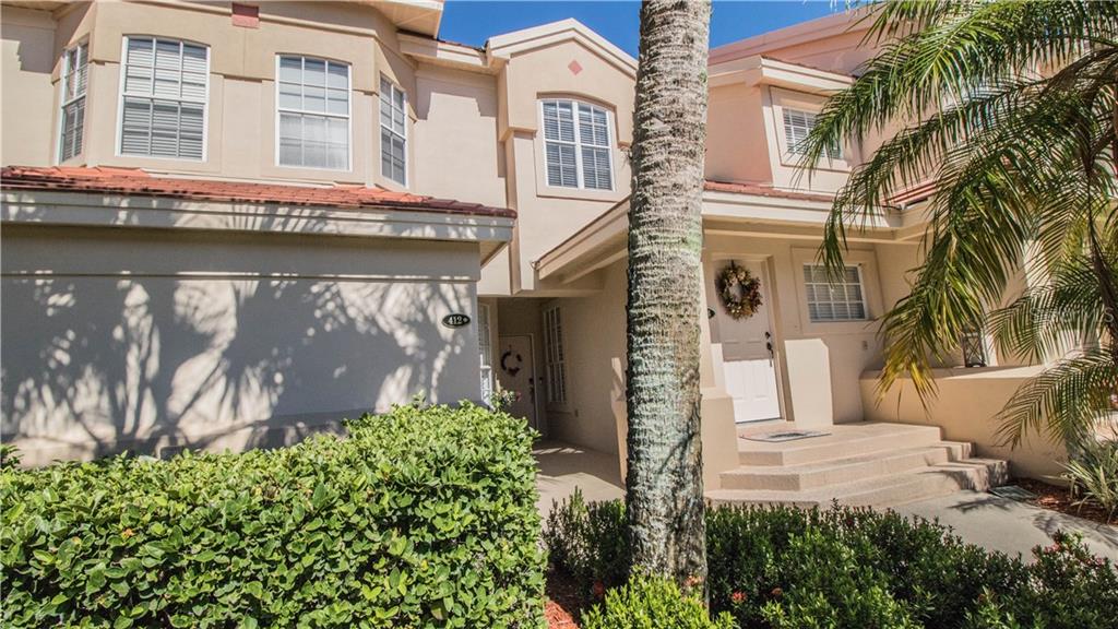 412 Enclave Place, Unit 412 Lakeland, FL 33803 - Photo 1 of 1 a front view of a house with a yard and garage