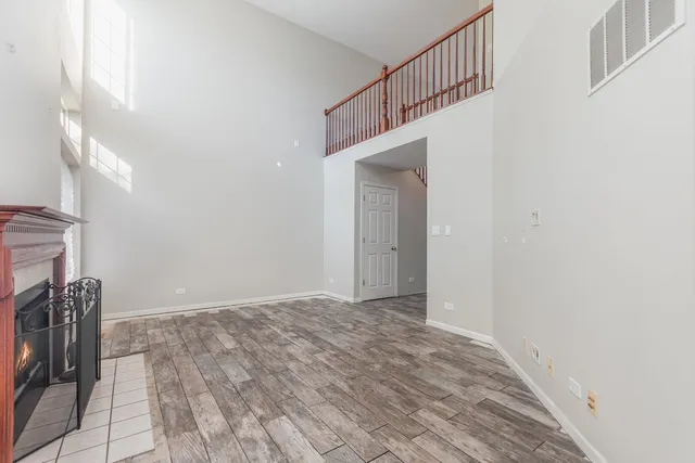 a view of empty room with window and fireplace