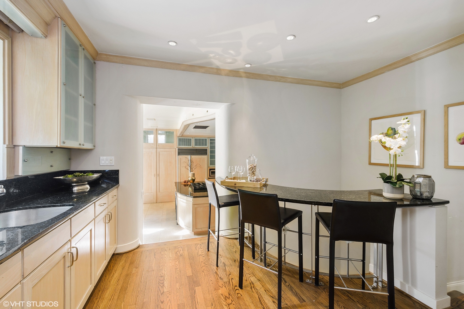 1442 North Astor Street Chicago, IL 60610 - Photo 20 of 55 a kitchen with granite countertop a stove a sink a dining table and chairs