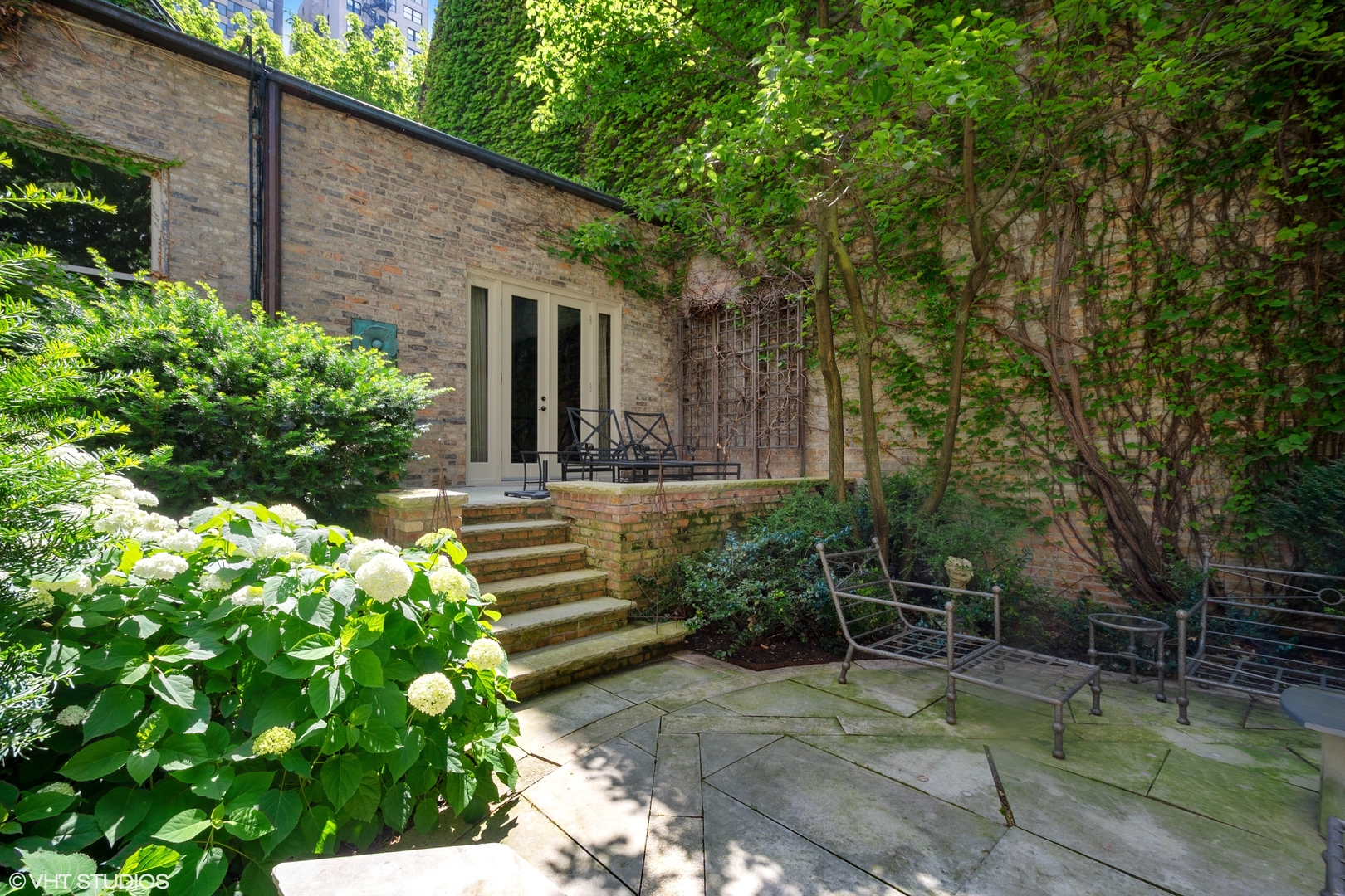 1442 North Astor Street Chicago, IL 60610 - Photo 52 of 55 a view of a chair and table in the garden front of house