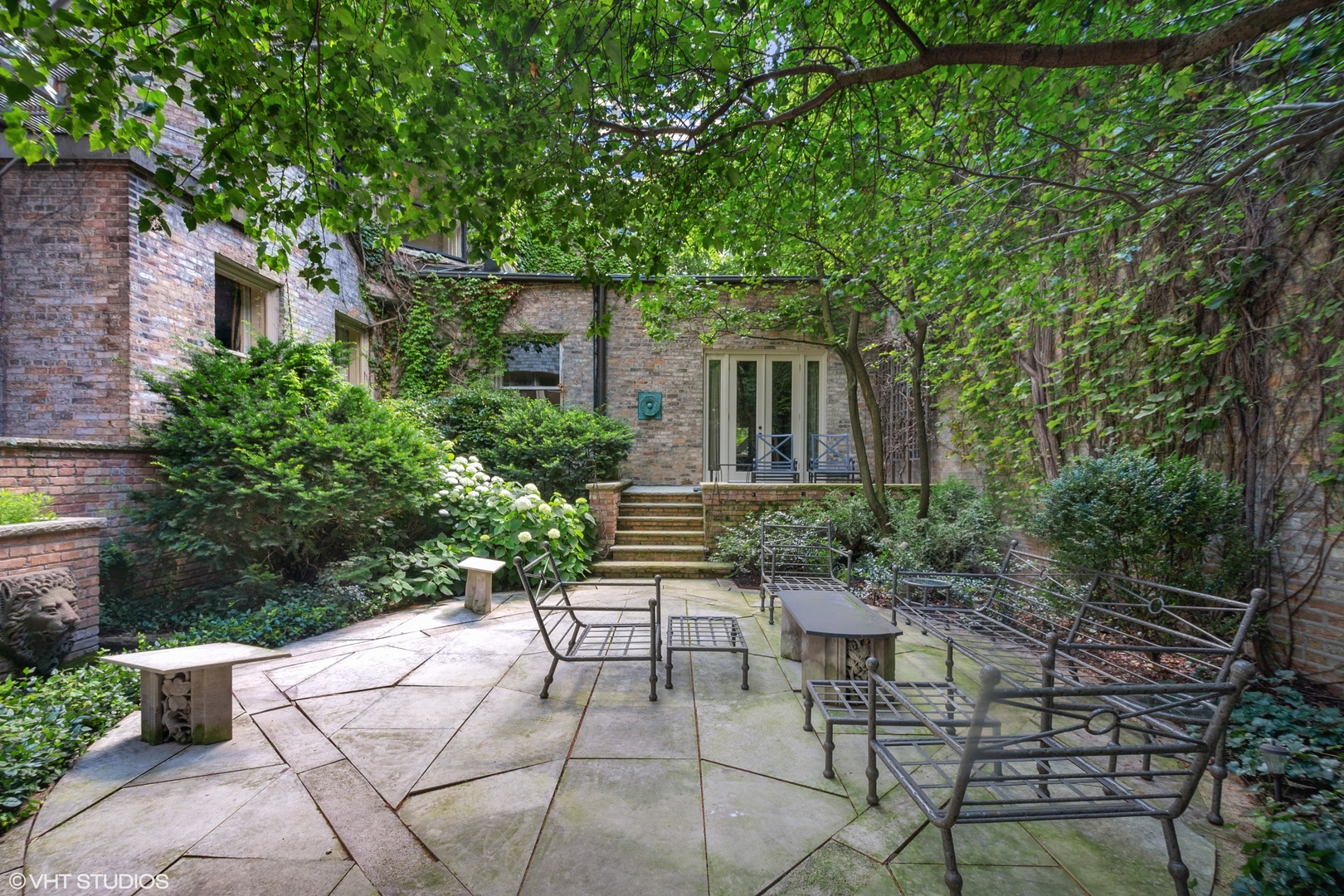 1442 North Astor Street Chicago, IL 60610 - Photo 54 of 55 a view of a patio with table and chairs and potted plants