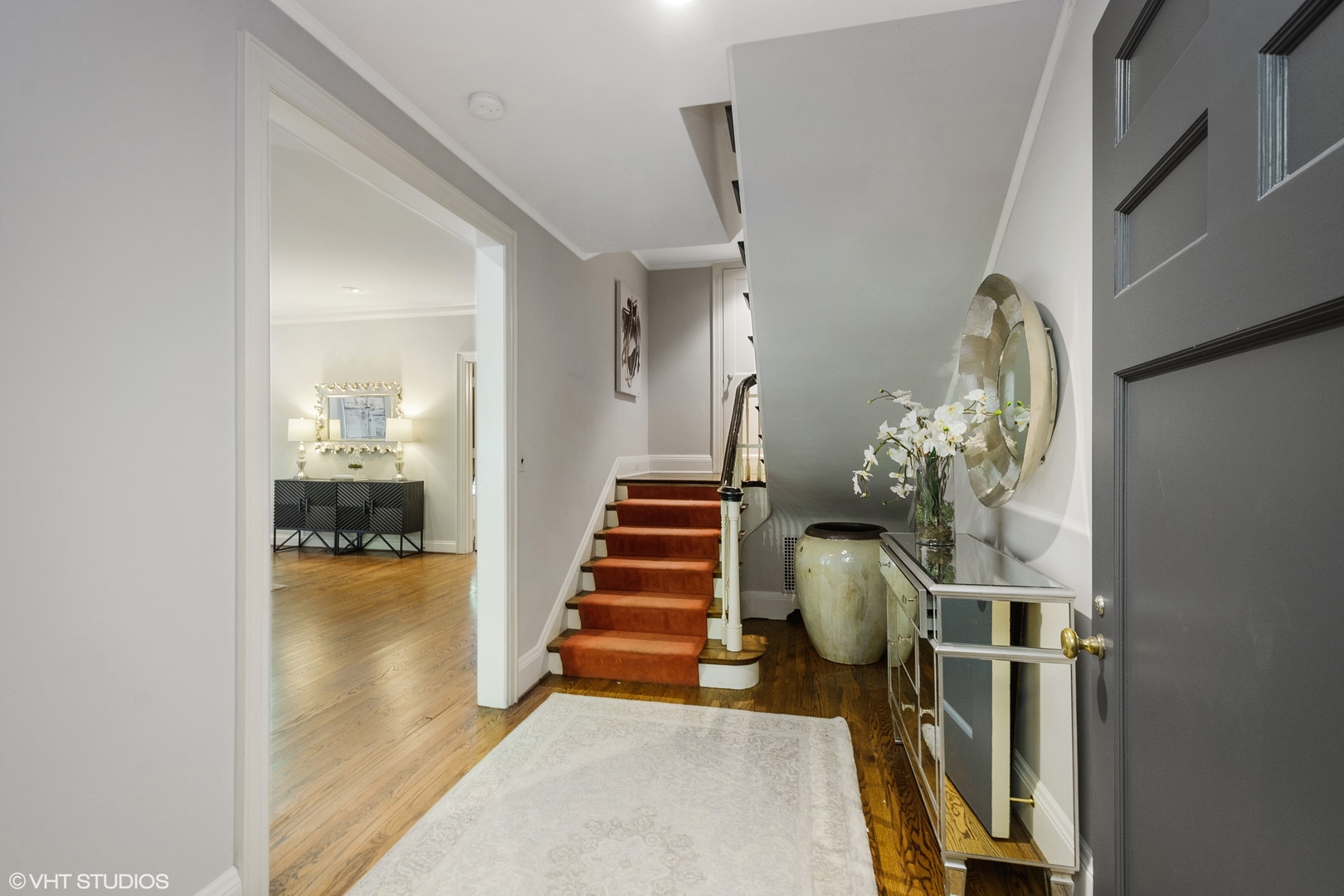 1442 North Astor Street Chicago, IL 60610 - Photo 8 of 55 a hallway with a chandelier and stairs