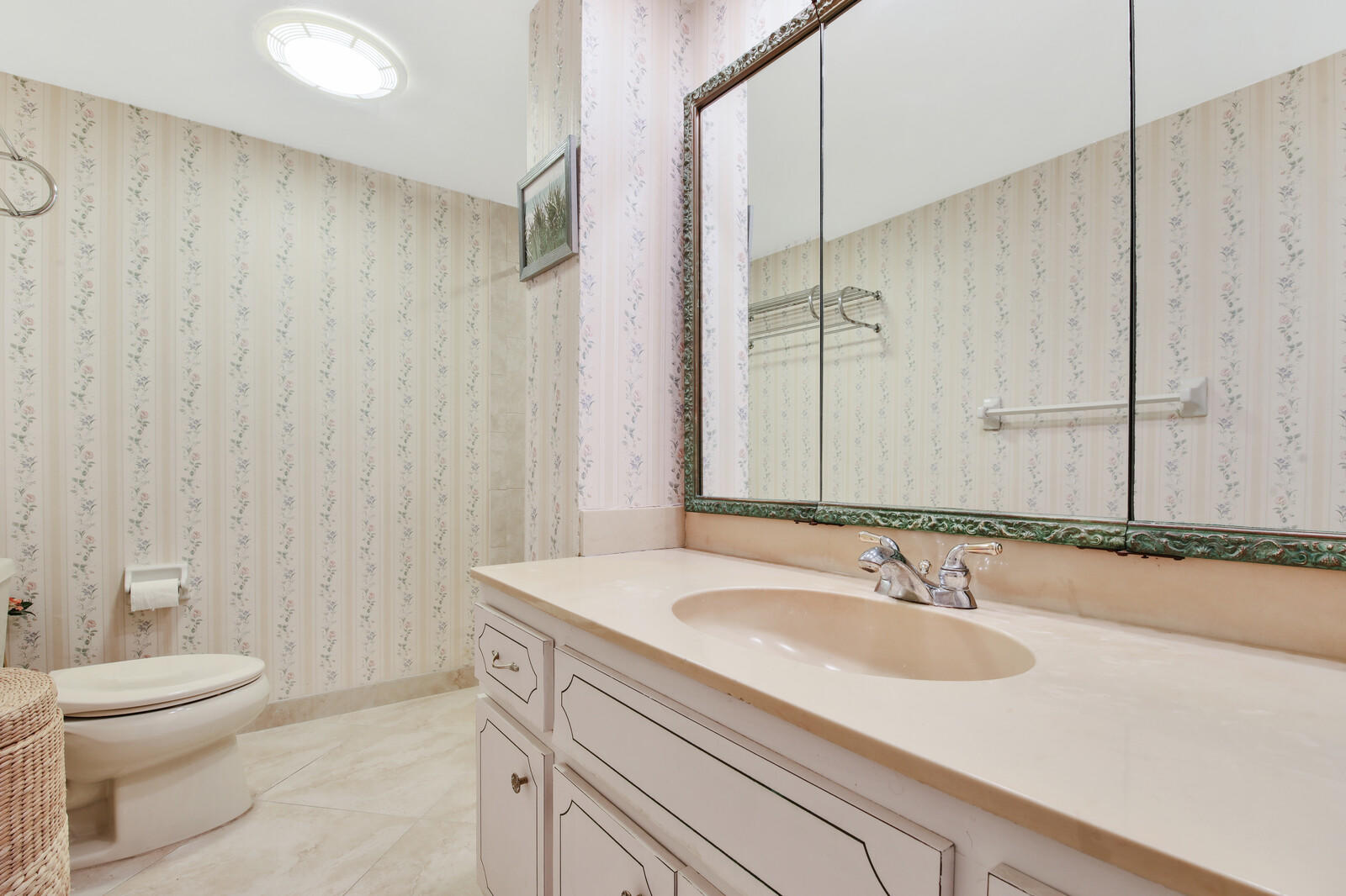 401 Briny Avenue, Unit 516 Pompano Beach, FL 33062 - Photo 17 of 38 a bathroom with a sink toilet a mirror and vanity