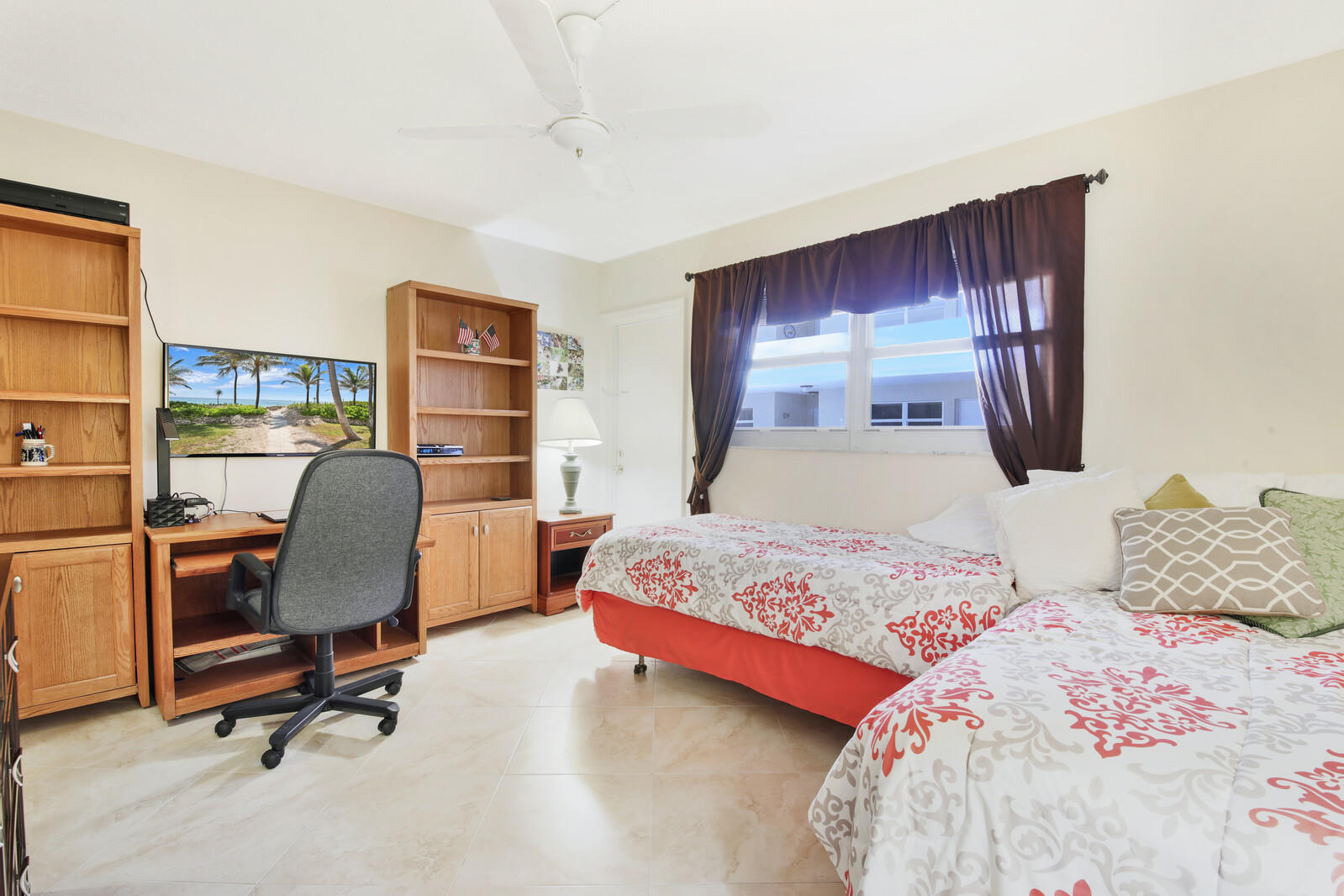 401 Briny Avenue, Unit 516 Pompano Beach, FL 33062 - Photo 18 of 38 a bedroom with a bed large window and desk