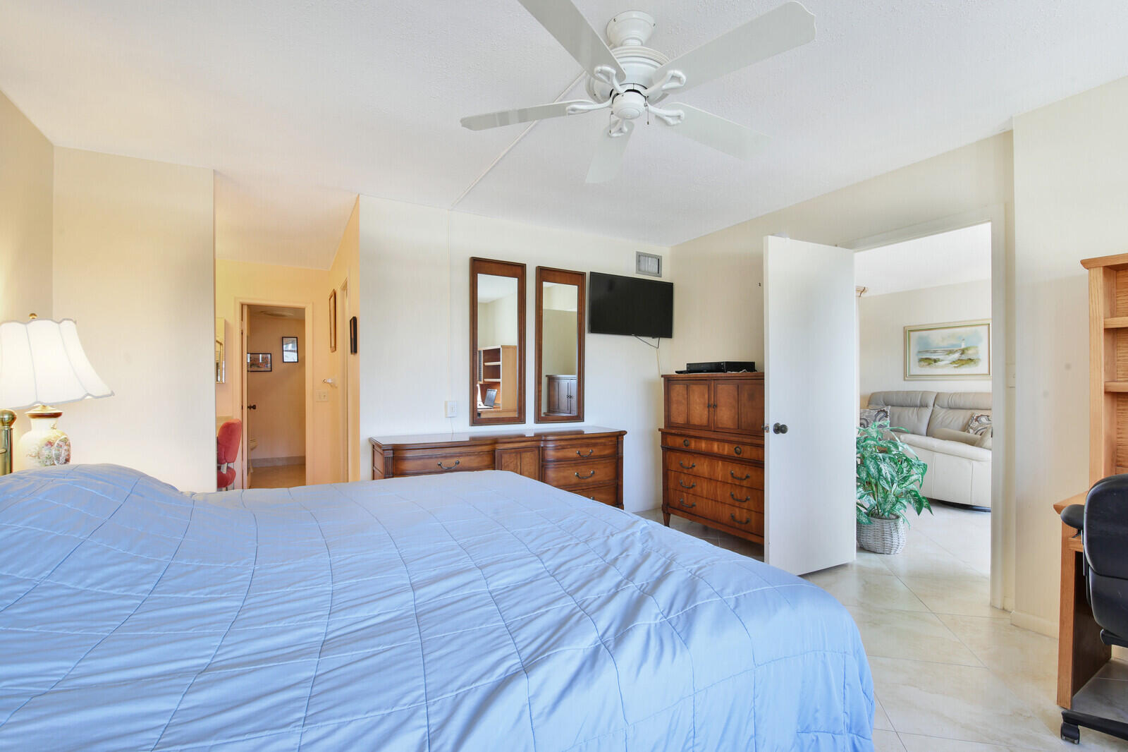 401 Briny Avenue, Unit 516 Pompano Beach, FL 33062 - Photo 23 of 38 a large bedroom with a large bed and dresser