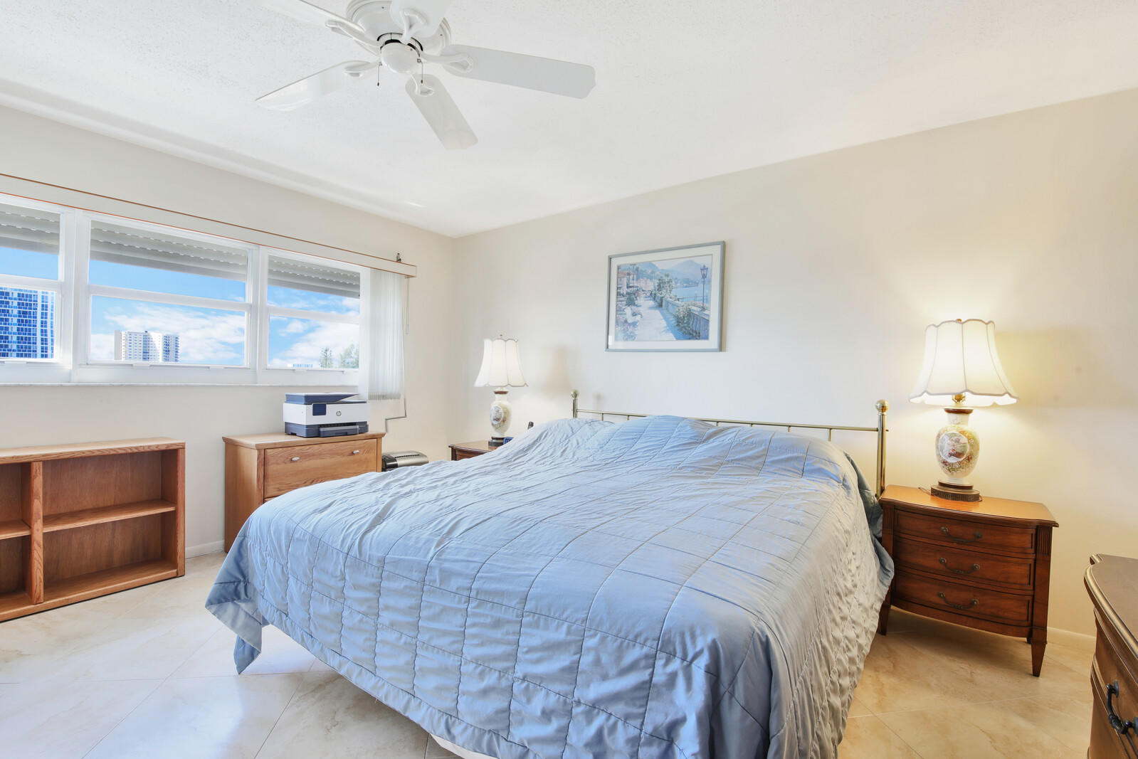 401 Briny Avenue, Unit 516 Pompano Beach, FL 33062 - Photo 24 of 38 a bedroom with a bed and a chandelier