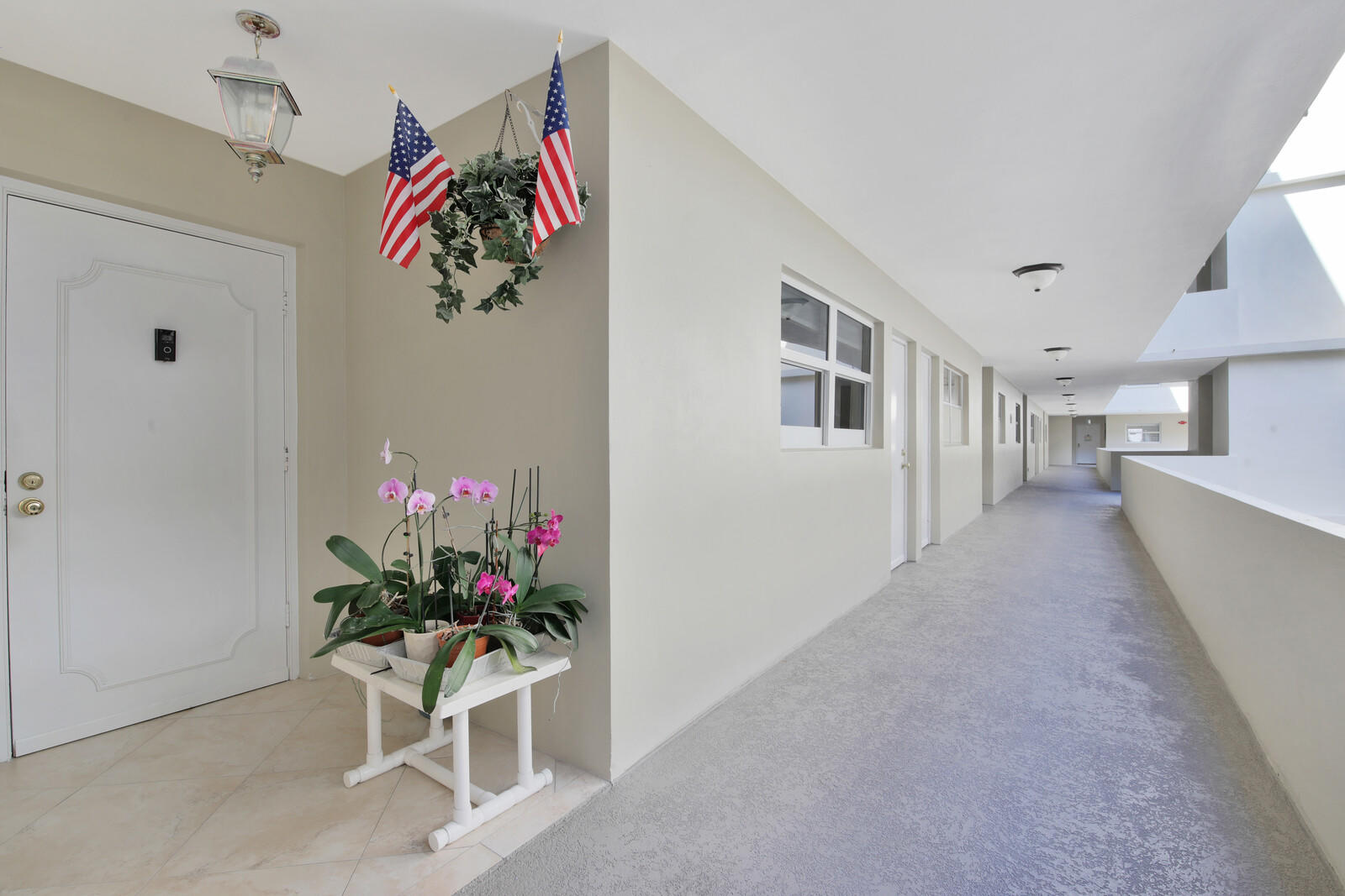 401 Briny Avenue, Unit 516 Pompano Beach, FL 33062 - Photo 31 of 38 a living room with furniture and flowers