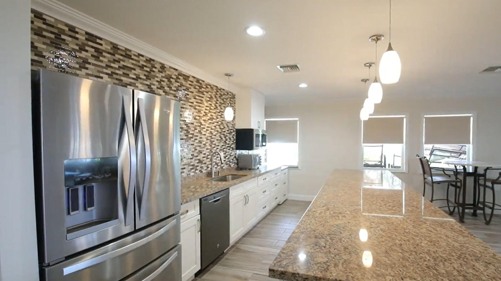 401 Briny Avenue, Unit 516 Pompano Beach, FL 33062 - Photo 36 of 38 a kitchen with stainless steel appliances granite countertop a refrigerator and a sink