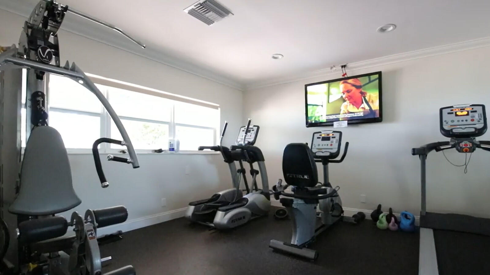 401 Briny Avenue, Unit 516 Pompano Beach, FL 33062 - Photo 37 of 38 a room with gym equipment and windows