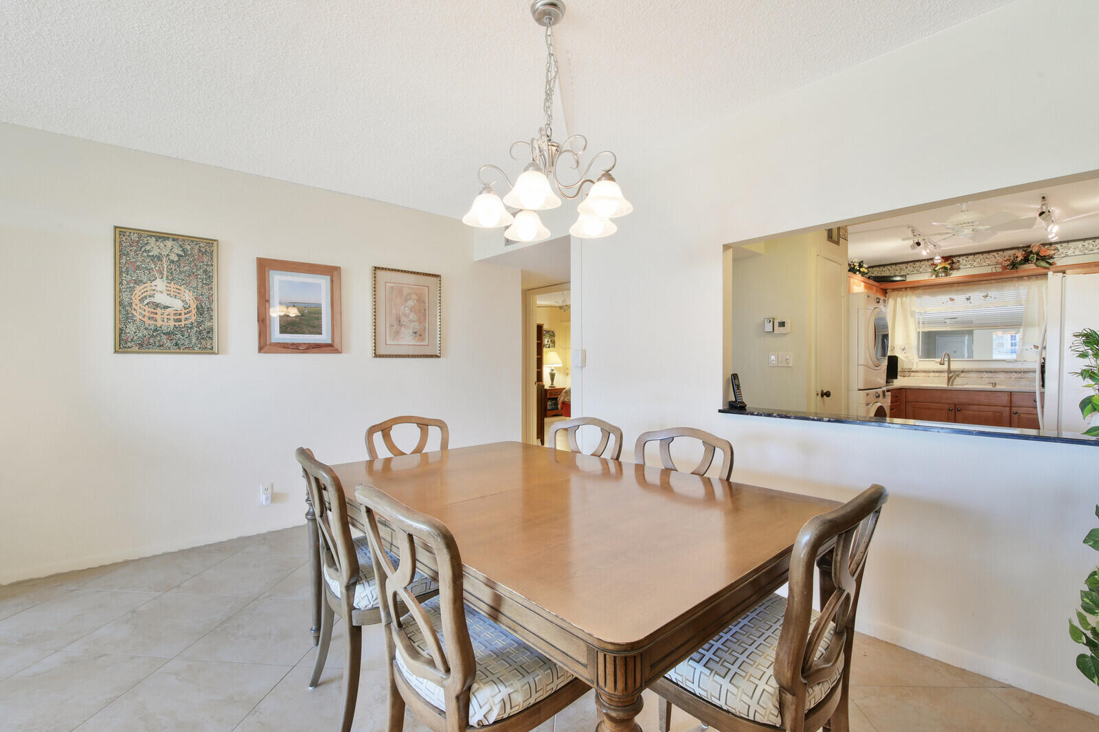 401 Briny Avenue, Unit 516 Pompano Beach, FL 33062 - Photo 10 of 38 a view of a dining room and a table and chairs in a room