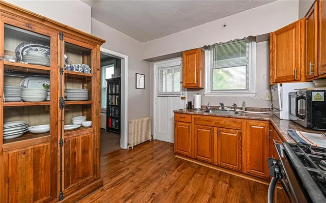 a kitchen with stainless steel appliances granite countertop wooden cabinets a sink and a stove