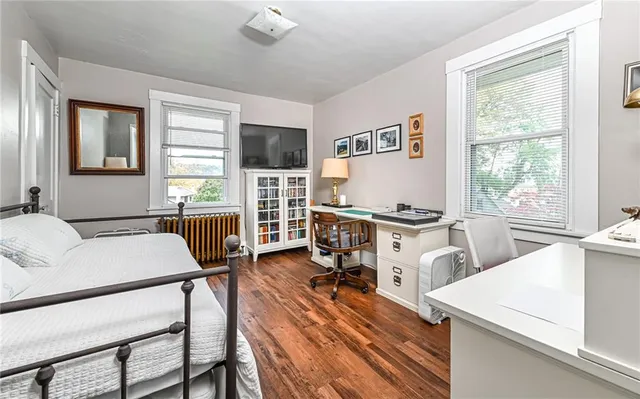 a living room with furniture a flat screen tv and a table