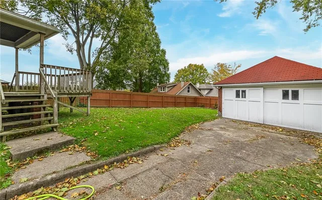 a view of house with backyard and a garden