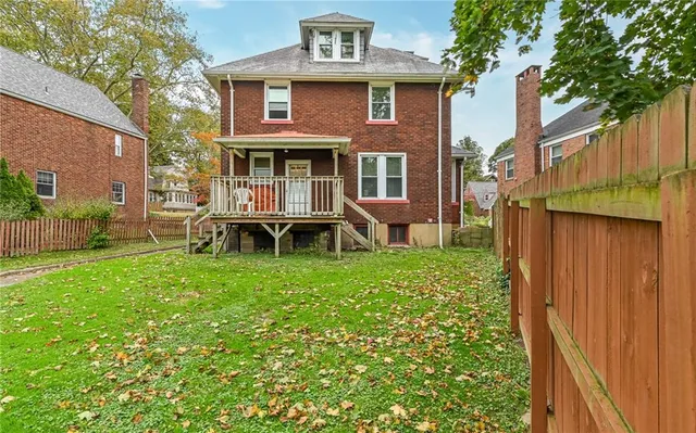 a view of a house with backyard sitting area and garden