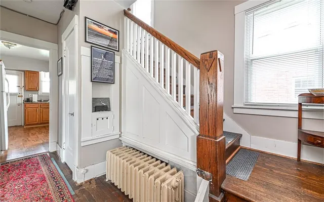 a view of an entryway with wooden floor and a livingroom