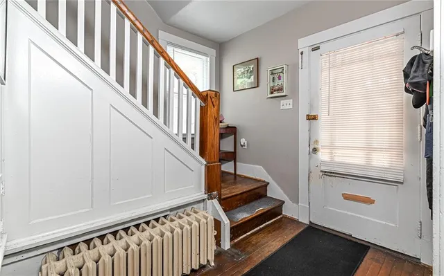a view of an entryway with wooden floor and stairs