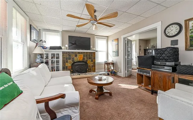 a living room with furniture a fireplace and a flat screen tv