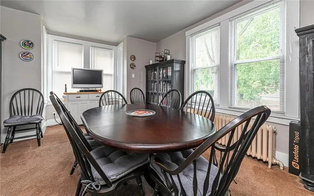 a view of a dining room with furniture window and outside view
