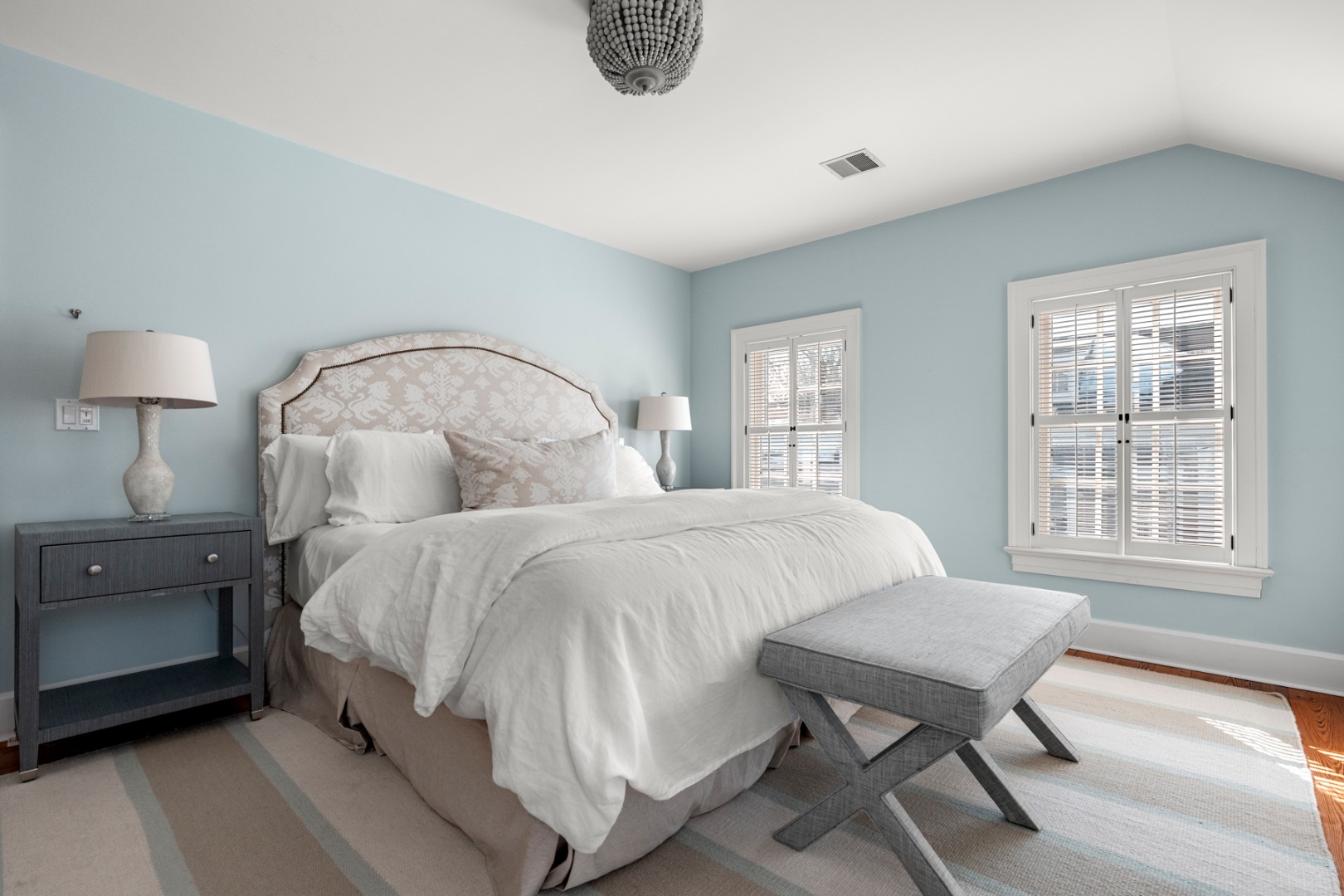 18 Mill Street Nantucket, MA 02554 - Photo 22 of 47 a spacious bedroom with a bed and a window
