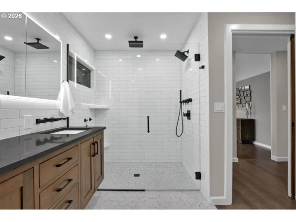 a bathroom with a shower sink and mirror