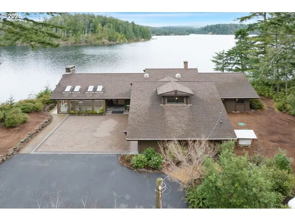 a view of a house with a yard and a lake view