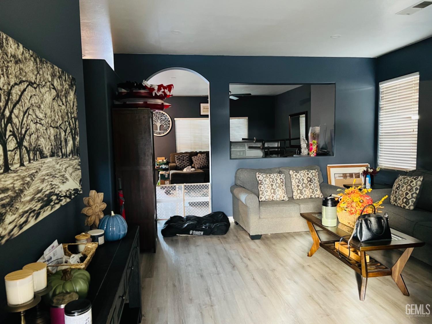 Undisclosed Address Bakersfield, CA 93313 - Photo 4 of 13 a living room with furniture and a wooden floor