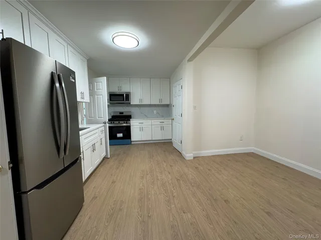 a kitchen with stainless steel appliances a refrigerator and a stove top oven
